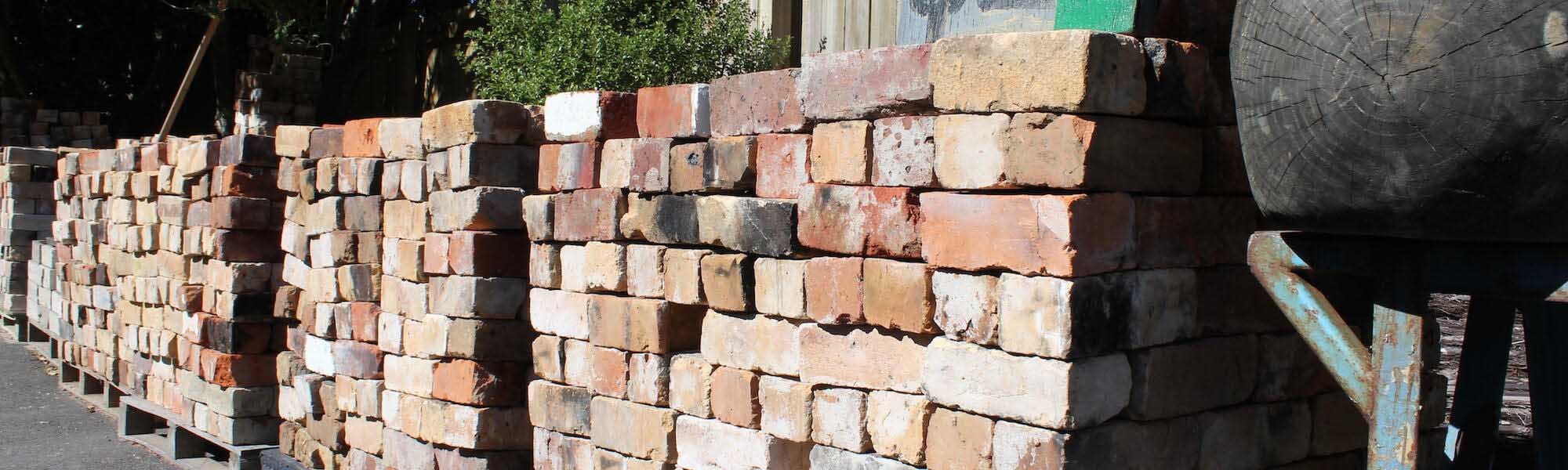 Rows of recycled bricks stacked in the Burrell Salvage yard
